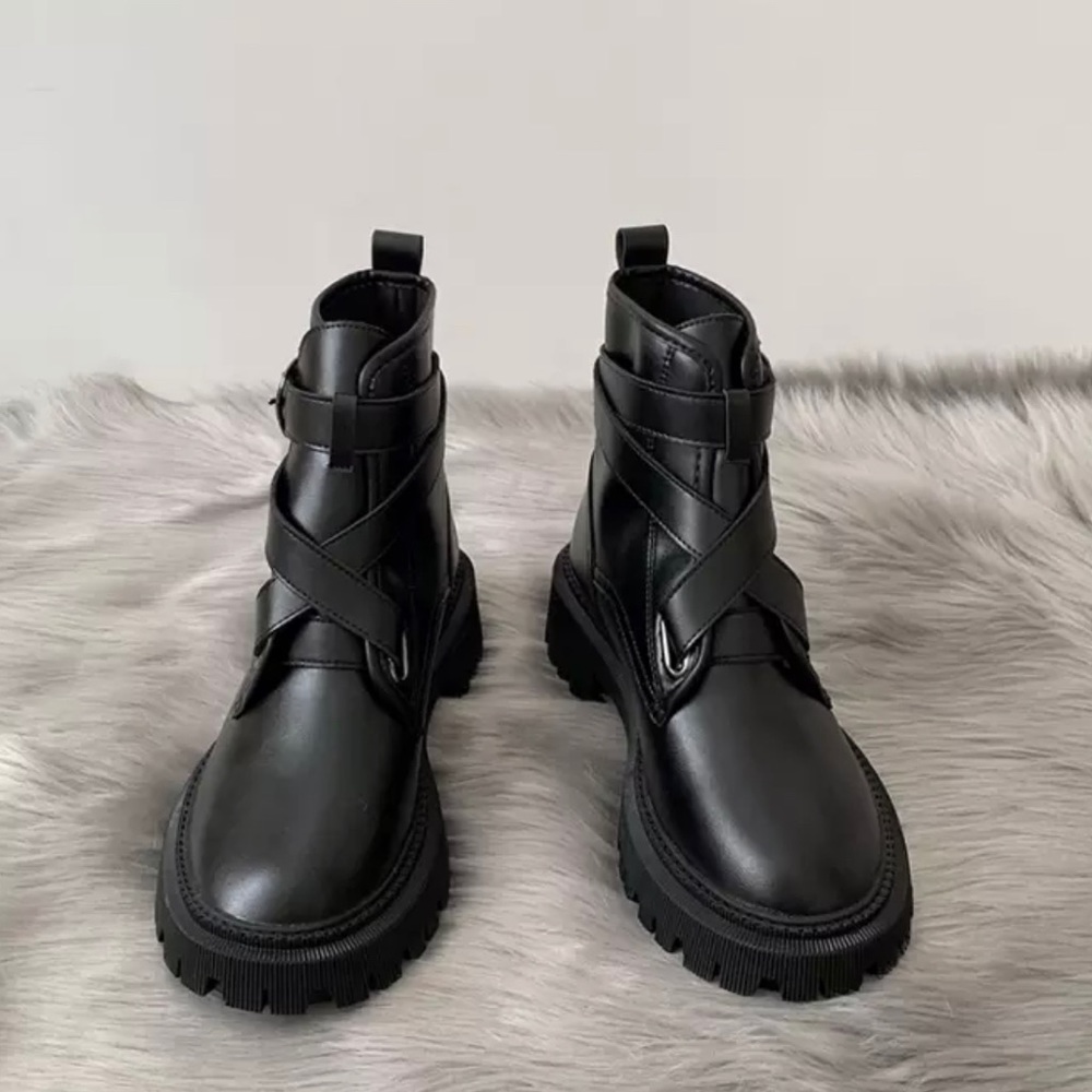 Chunky black combat boots with cross front strap detail